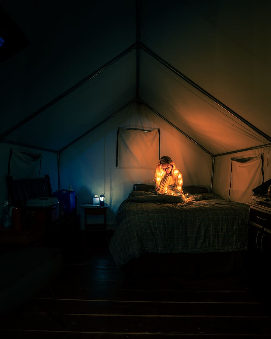 woman sitting on bed, tent, camping, light, person, blanket, nightlight HD wallpaper