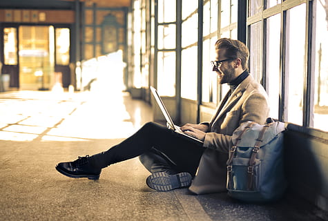 HD wallpaper: Young Adult Man using a laptop and smiling inside an empty passage during a daytime - Wallpaper Flare