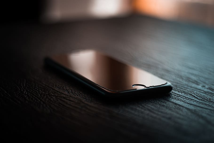 Selective Focus Photography of Black Iphone Turned-off on Table HD wallpaper