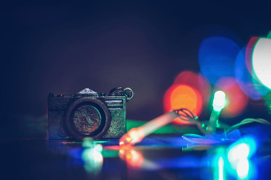 Photo of Black Camera Near Green and Red Strip Lights, blur, bokeh HD wallpaper