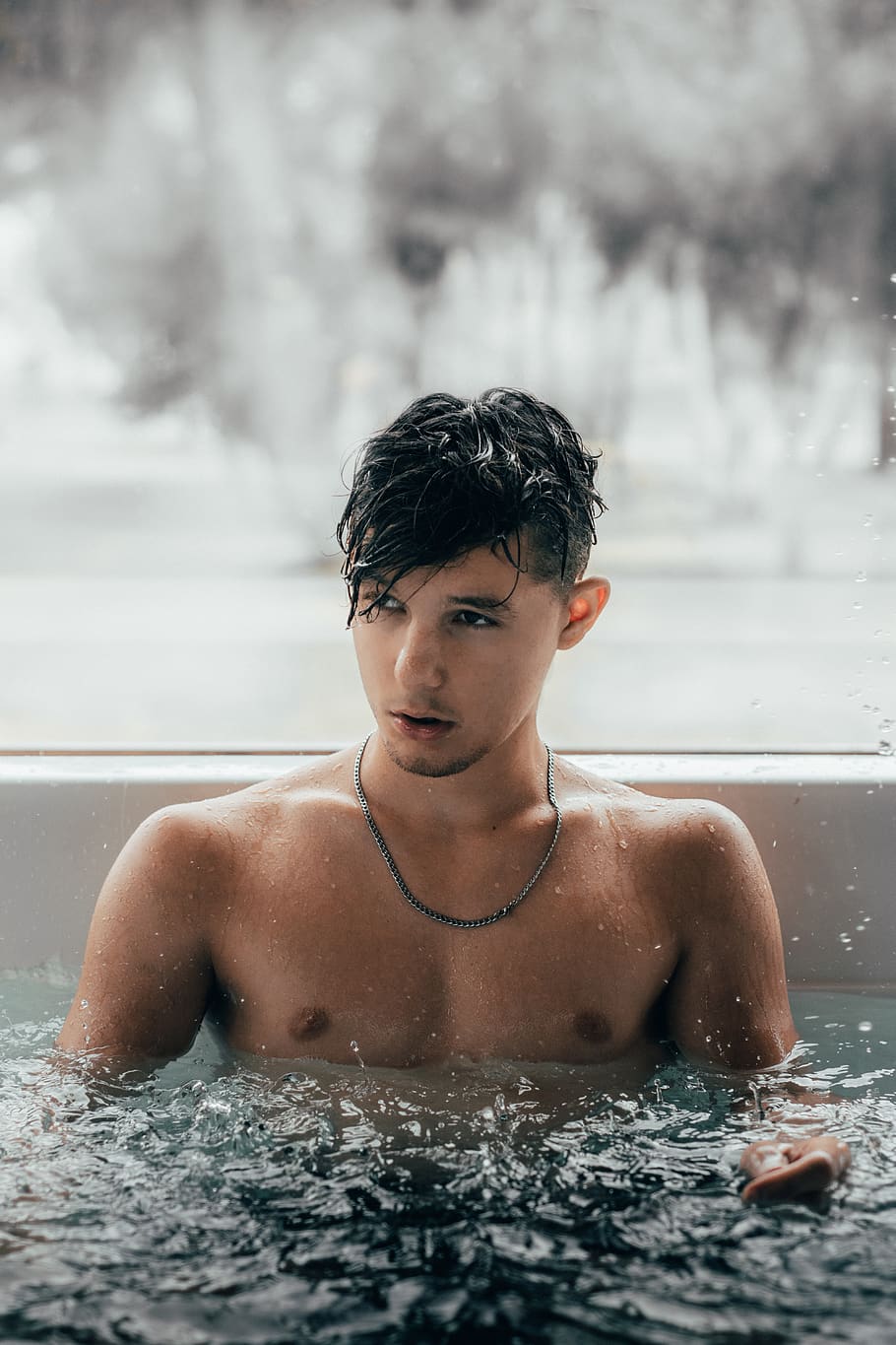 man wearing black necklace in pool, person, human, tub, hot tub