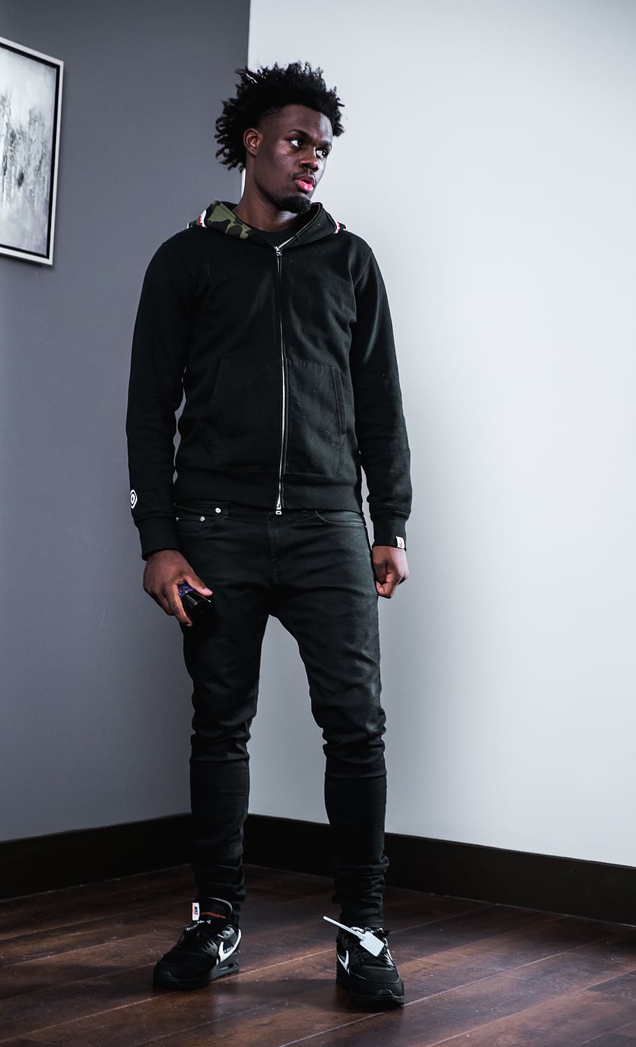 man wearing black full-zip jacket standing on wooden parquet floor, HD wallpaper