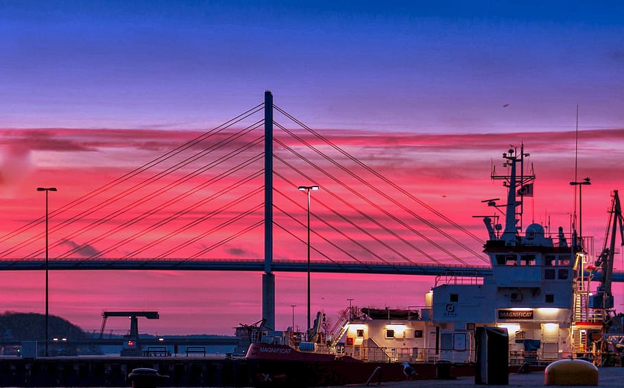 Silhouette of a Bridge Under Red Clouds and Blue Sky Taken during Night Time HD wallpaper