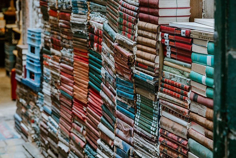 stack of assorted-title books, pile, outdoors, old, worn, vintage HD wallpaper
