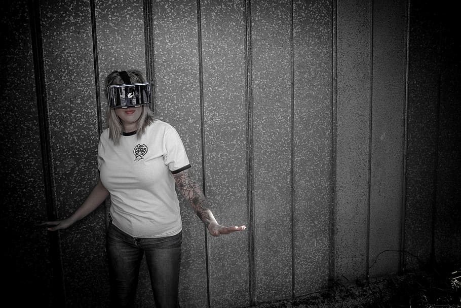Woman Wearing Virtual Reality Headset Standing Beside Wall, female