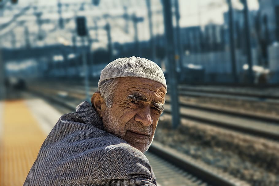 old man, hat, blazer, train tracks, train station, one person HD wallpaper