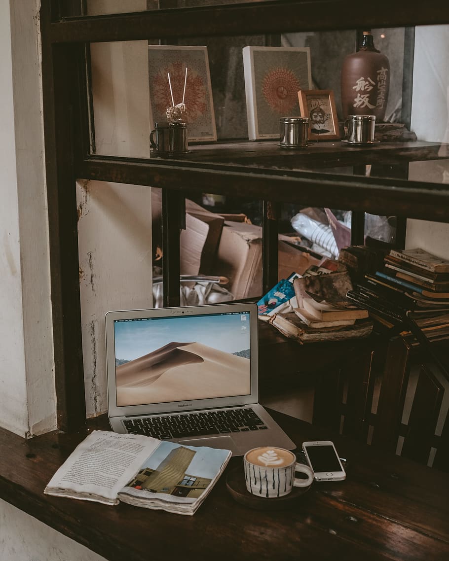MacBook Air beside cup of coffee latte and smartphone, coffeeshop HD wallpaper