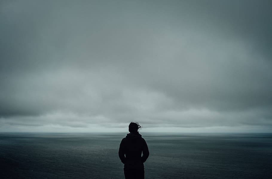 HD wallpaper: person standing near body of water, ocean, grey sky, fog, hair  blowing | Wallpaper Flare