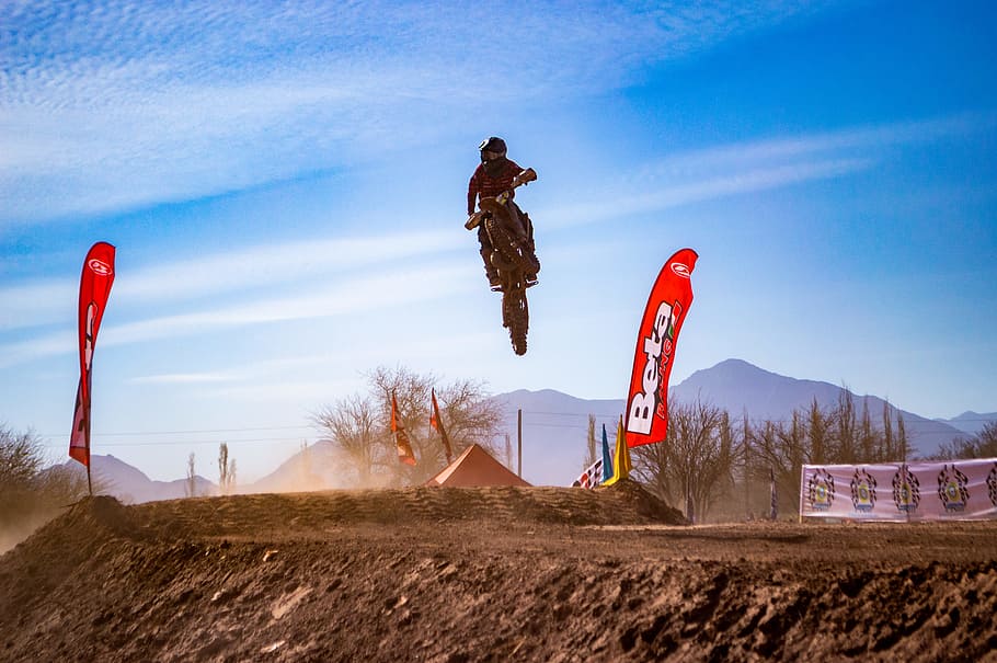 Man Riding Motocross Dirt Bike Doing Stunt, action, clouds, daylight HD wallpaper