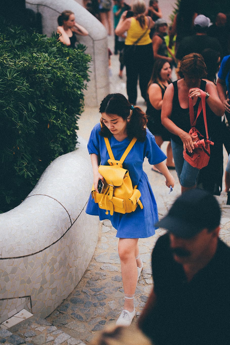 Woman in Blue Dress With Yellow Knapsack Walking Near People HD wallpaper