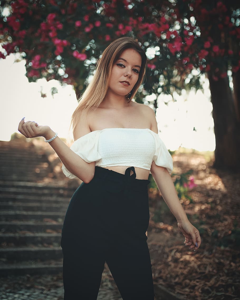 woman in white off-shoulder crop top and black high-waisted pants