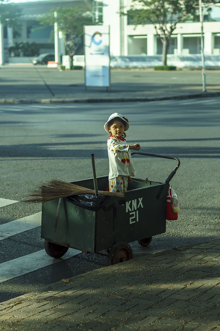 girl on wagon, tarmac, asphalt, road, person, human, machine
