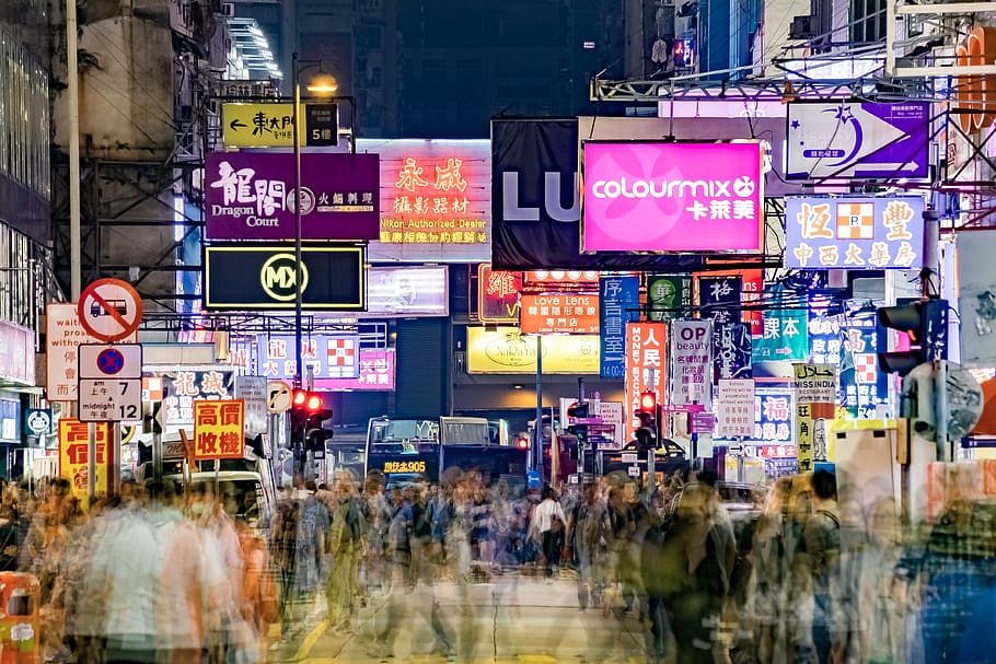 crowd-walking-surrounded-by-buildings-during-night-time.jpg