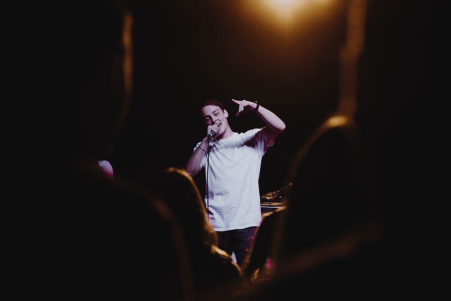 man raising his left hand while singing, person, human, people HD wallpaper
