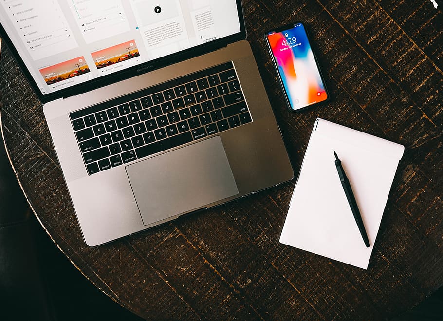 MacBook beside iPhone X on brown table, technology, communication HD wallpaper