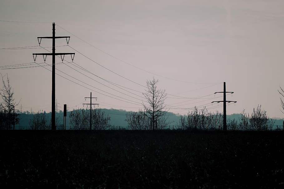 silhouette photo of transmission post, power lines, cable, electric transmission tower