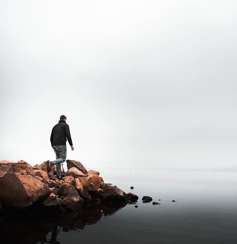 man walking on rocks beside beach, water, rock - object, solid HD wallpaper