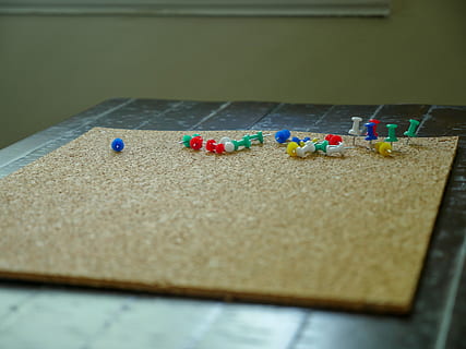An assortment of colorful push pins on a bulletin board, cork HD wallpaper