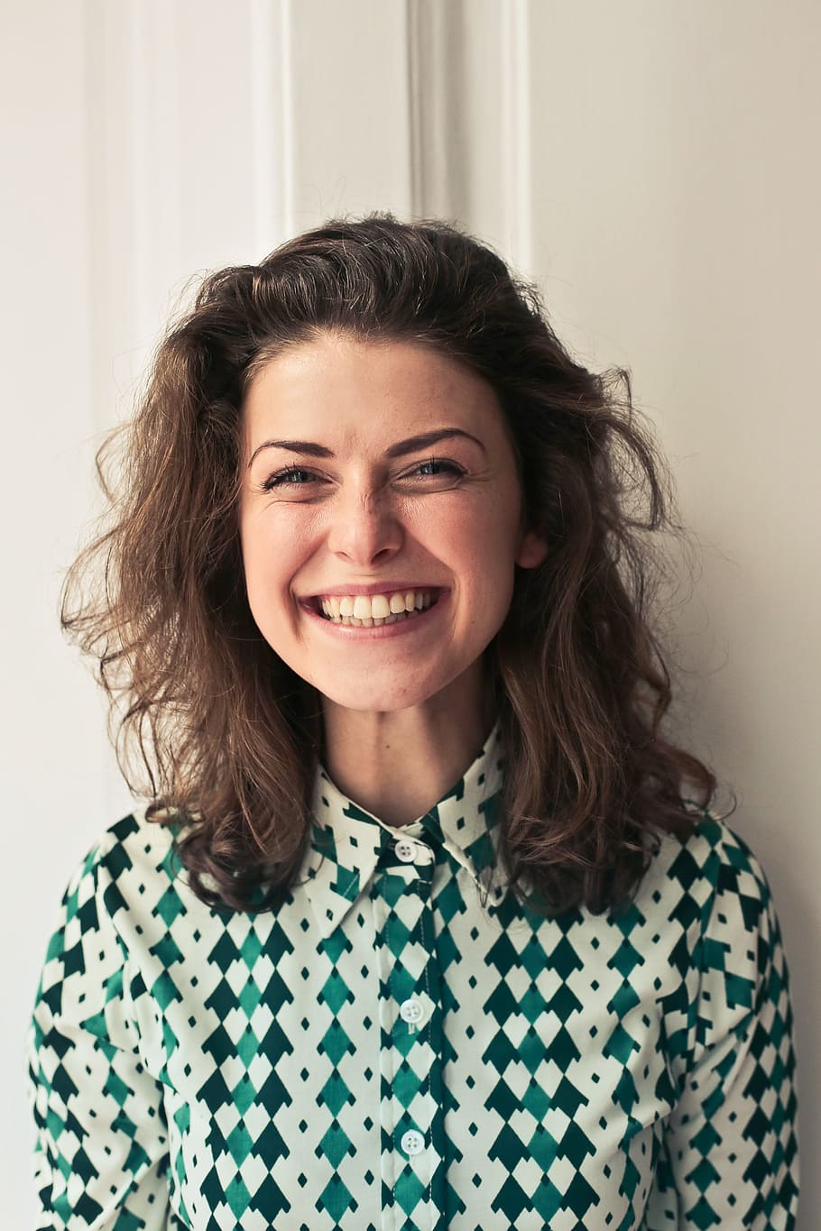 Portrait Of Young woman in printed collared shirt seen smiling as looking at camera