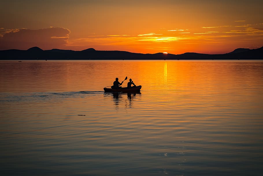 2 Person on Boat Sailing in Clear Water during Sunset, backlit HD wallpaper