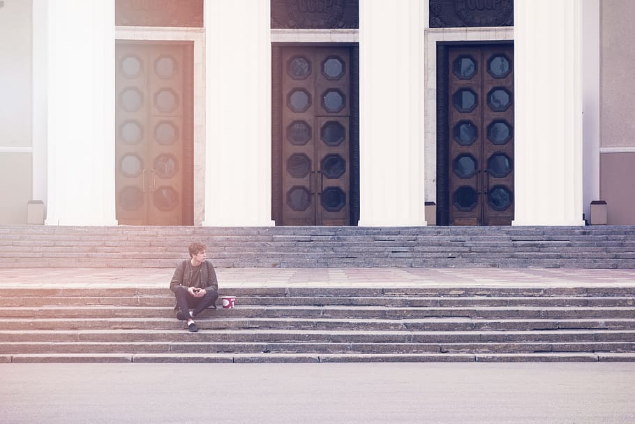 Man Sitting on a Concrete Stair Waiting for Someone during Daytime HD wallpaper