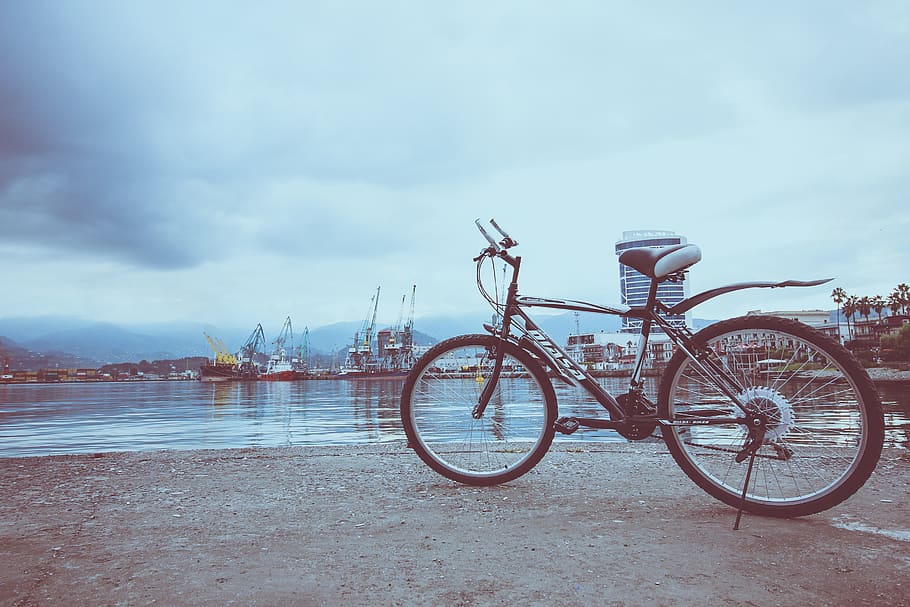 Black Bicycle Near Water, bicycle parking, clouds, daylight, daytime HD wallpaper