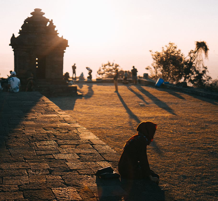 Person Sitting on Ground Outdoors, architecture, backlit, cobblestone HD wallpaper