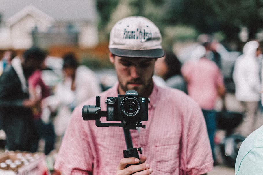 selective focus photography of man holding camera, photographer HD wallpaper