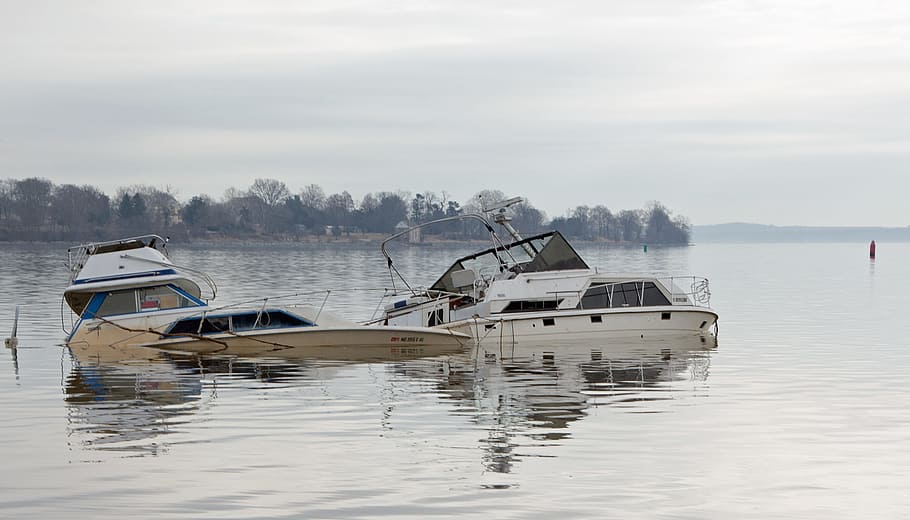 Small boats damaged and sunk in the Susquehanna river after a storm.