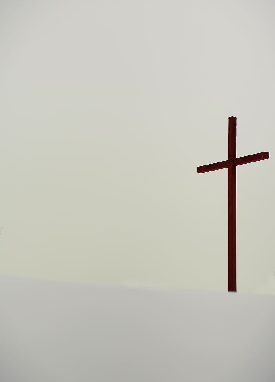 A tall cross statue in the backdrop., symbol, calvary, crucifix