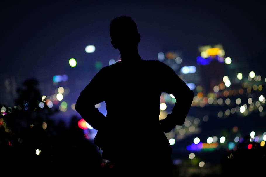 person standing behind lights, night, silhouette, one person HD wallpaper