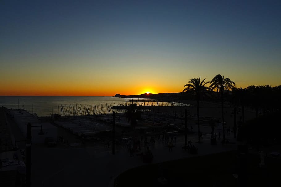 spain, sitges, ocean, sun, sunset, boat, palms, sky, sea, water HD wallpaper