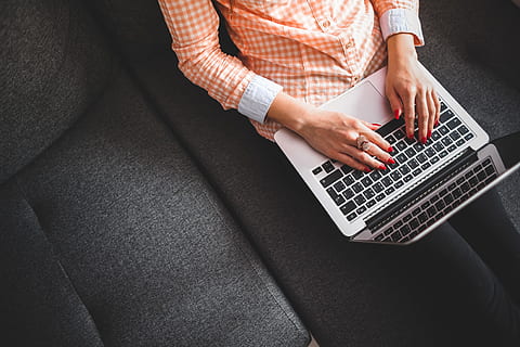 Girl Writing on the Sofa, computer, hands, home, laptop, learning HD wallpaper