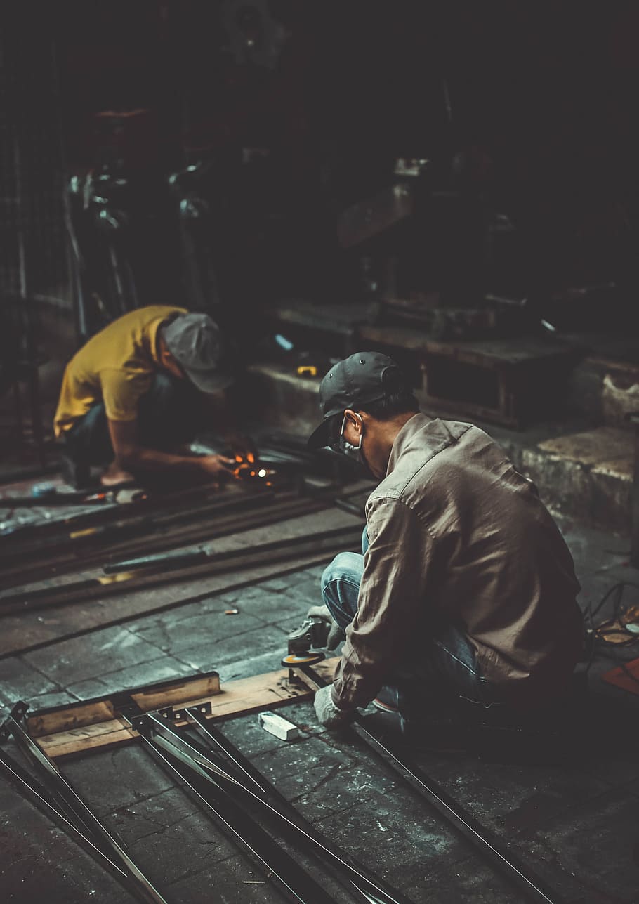 man holding angle grinder and metal rod, workman, construction HD wallpaper