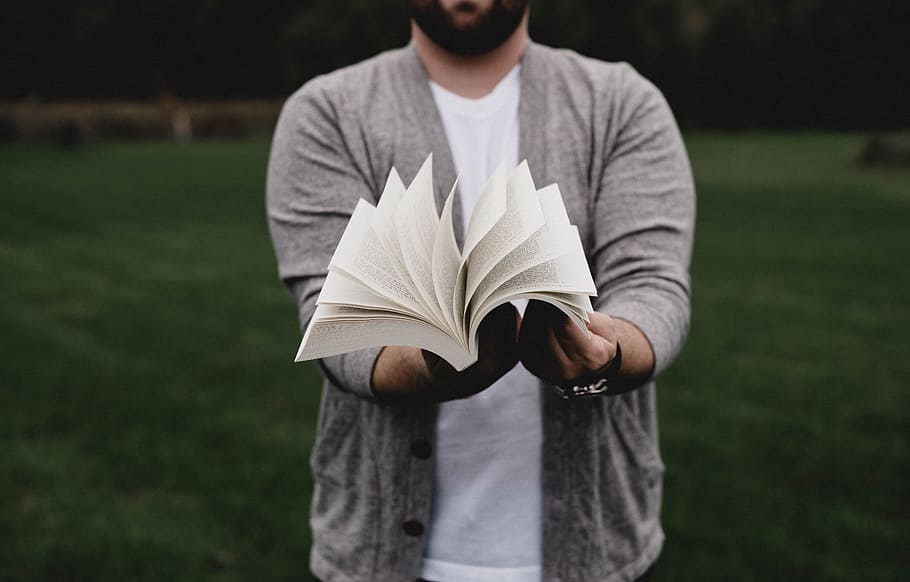 person opening book, man, pages, flick, outdoors, cardigan, fashion HD wallpaper