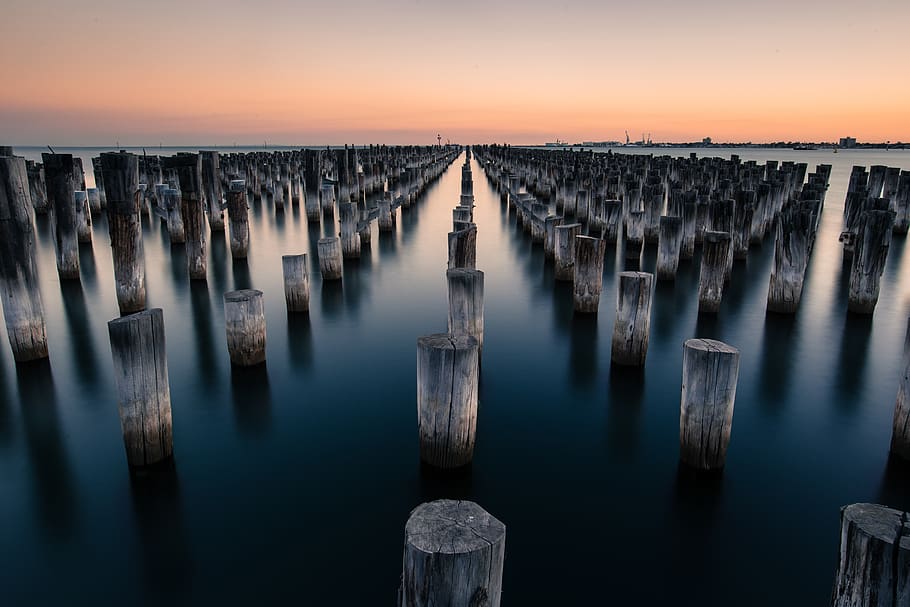 logs, nature, pattern, pillars, shadow, sunset, water, wooden HD wallpaper