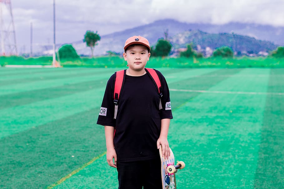 Photo of Boy Holding Skateboard, cap, field, fun, leisure, outdoors HD wallpaper