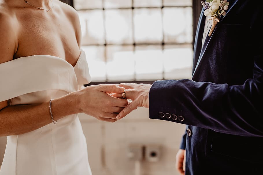 Woman Putting Wedding Ring On Groom's Finger, bride, Bride and Groom