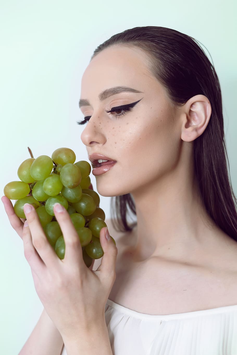 Photo of Woman About to Eat White Grapes, beautiful woman, brunette