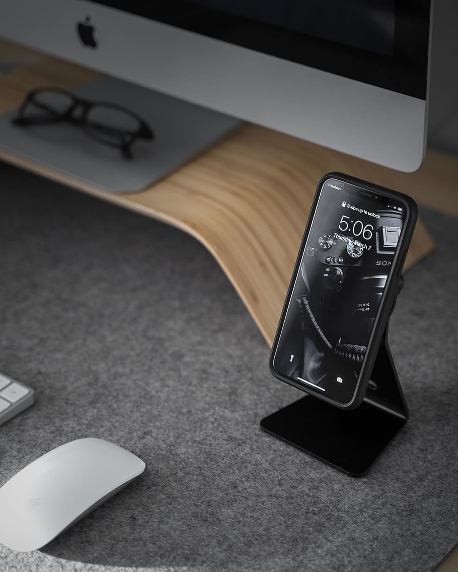 black smartphone near white iMac, technology, communication, text HD wallpaper