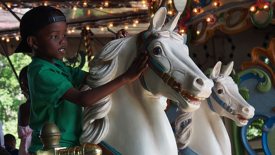 Boy Wearing Green Polo Shirt Riding Carousel, carnival, child