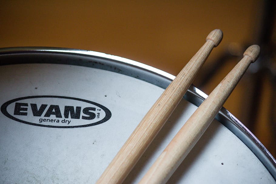 drumsticks on Evans drum, text, no people, indoors, wood - material