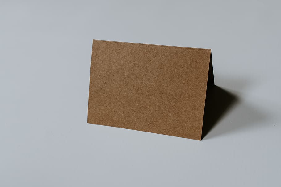 brown hardbound book on white surface, paper, single object, copy space HD wallpaper