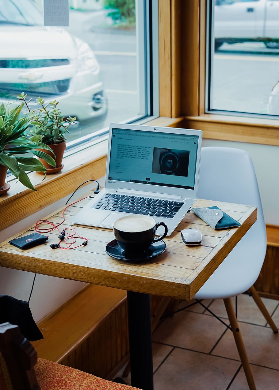 cup of coffee, laptop computer, and red earphones plugged in laptop on brown wooden table HD wallpaper
