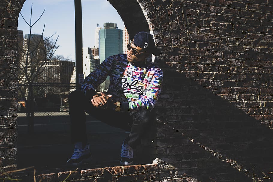 Man Leaning on Brick Wall, cap, city, daylight, eyewear, fashion HD wallpaper