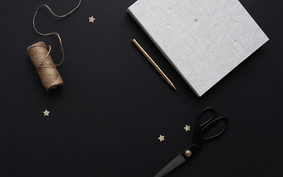 brown thread roll beside white book, indoors, art and craft, studio shot HD wallpaper