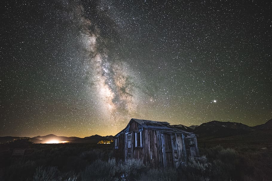 brown and gray wooden house under stars on sky during nighttime HD wallpaper