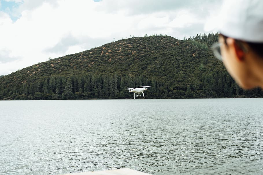 white quadcopter drone near body of water, lake, forest, bokeh HD wallpaper