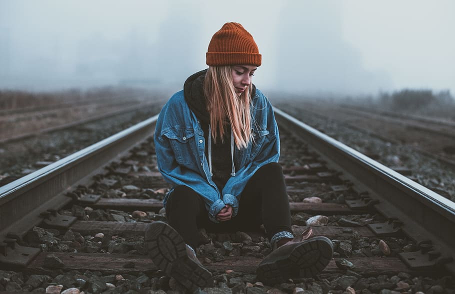 sitting, train, train tracks, girl, blonde, woman, lady, beanie HD wallpaper