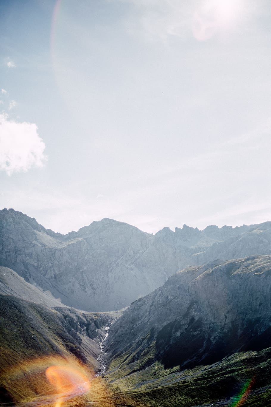 photo of valley near gray concrete mountain, landscape, haze HD wallpaper